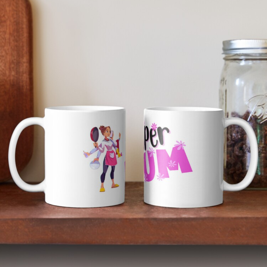 White coffee mug with a super mum design showing "super mum" in bold pink and black and a mum with several arms holding multiple items signifying mum can do all the things