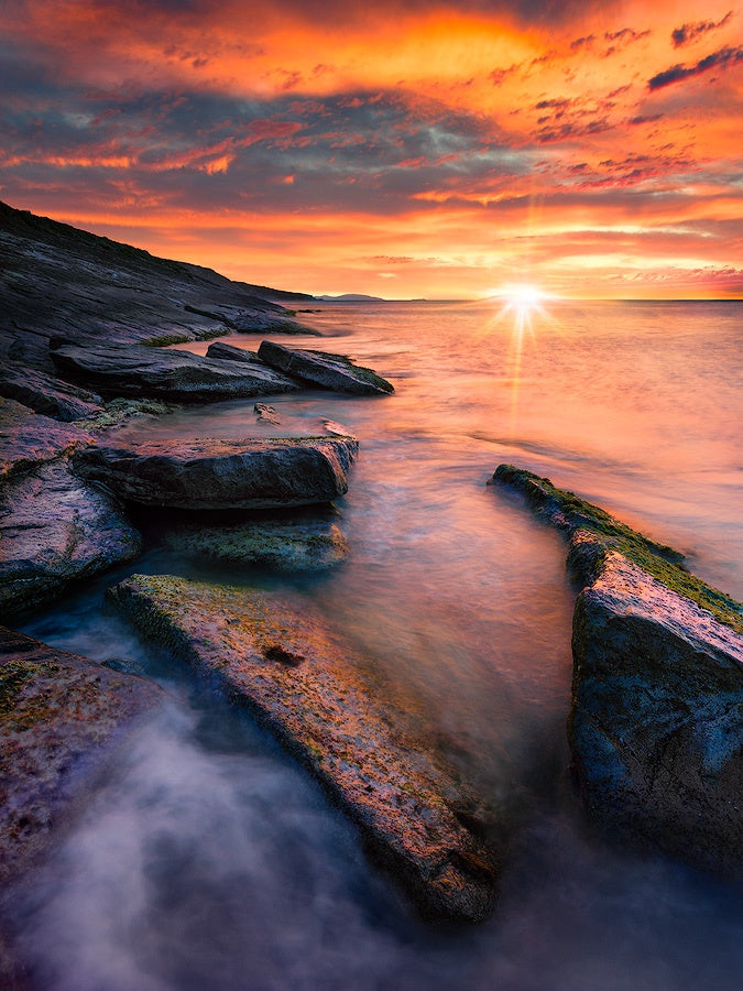 Beautiful sun starburst in seascape sunset image of Cape Le Grand Beach in Esperance Western Australia