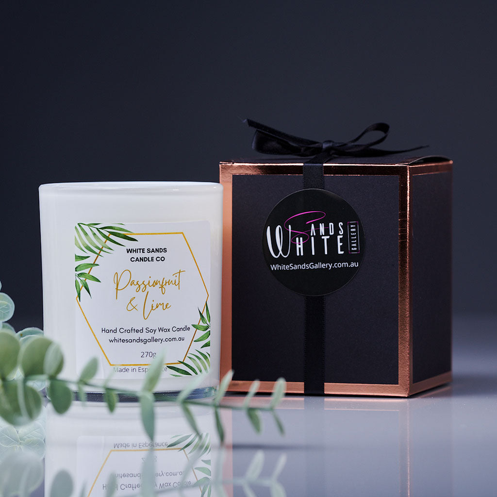product photo of a soy wax candle in a white jar with a black gift box tied with a black ribbon