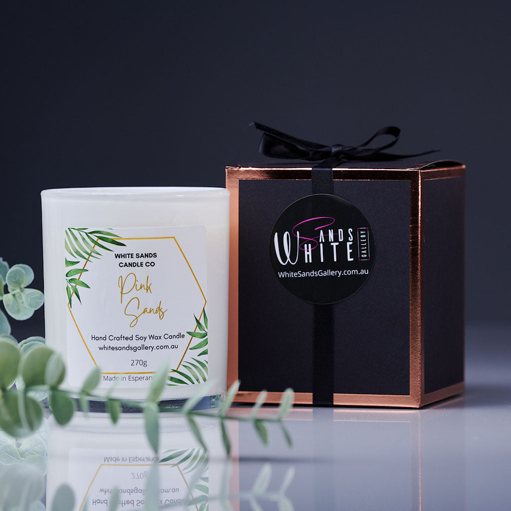 product photo of a soy wax candle in a white jar with a black gift box tied with a black ribbon