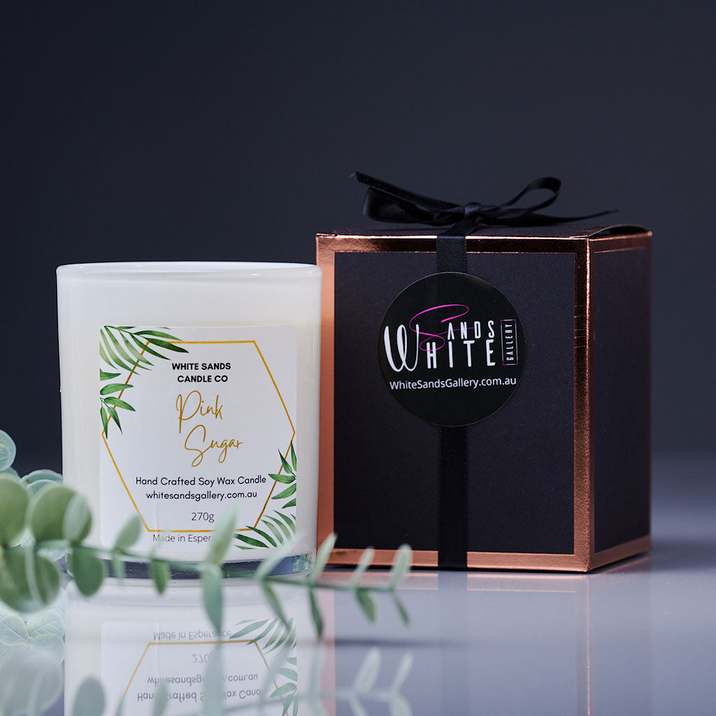 product photo of a soy wax candle in a white jar with a black gift box tied with a black ribbon
