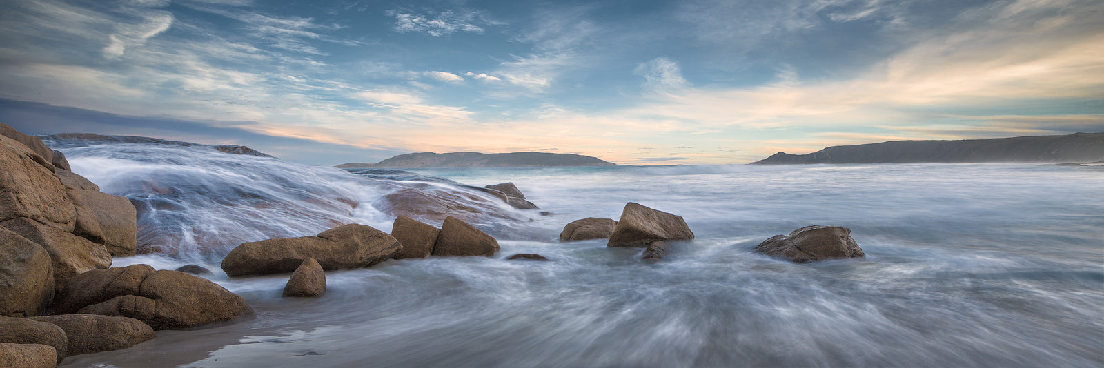 Dolphin Cove Dreamy water over rocky scene with beautiful clouds
