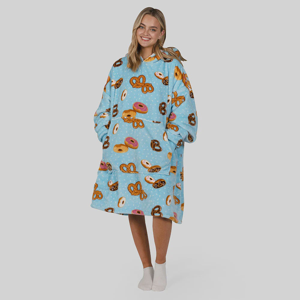 hooded blanket mostly pale blue with pictures of donuts and pretzels all over worn by a woman