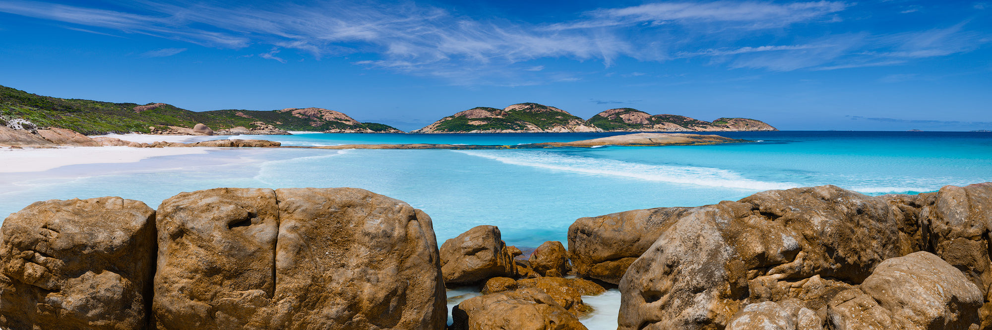 Lucky Bay from the end of the first bay viewing the second and third bays aqua water with rocks in foreground Esperance panorama