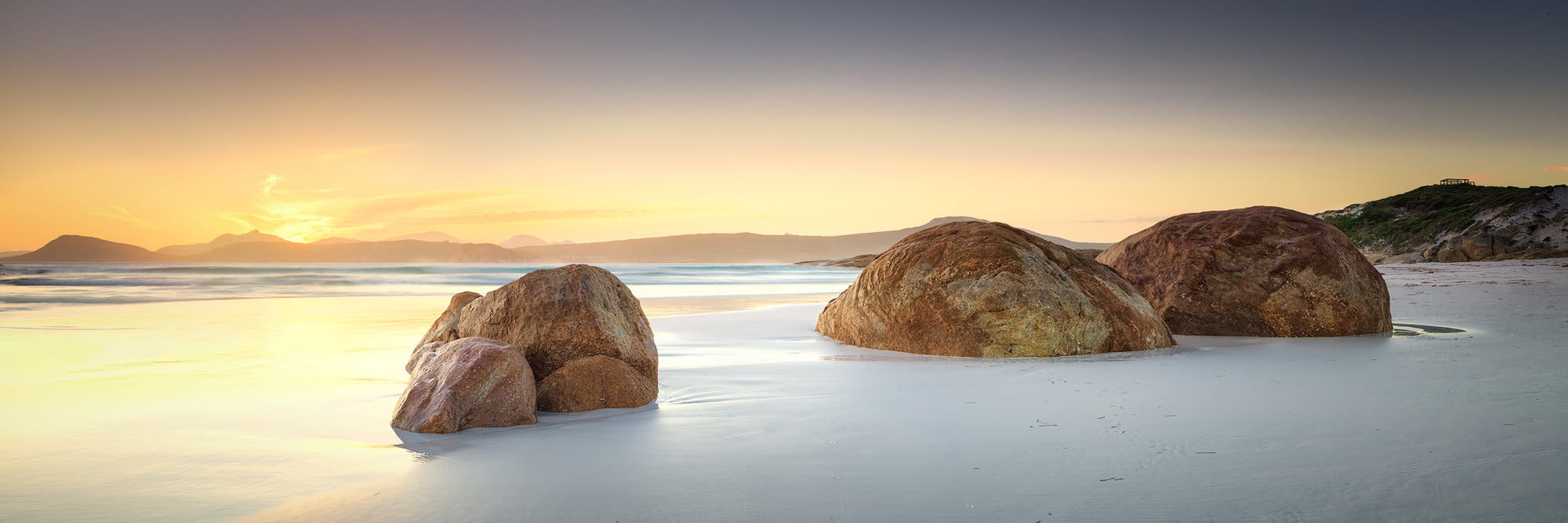 Sunset at Lucky Bay Esperance with three rocks in the foreground