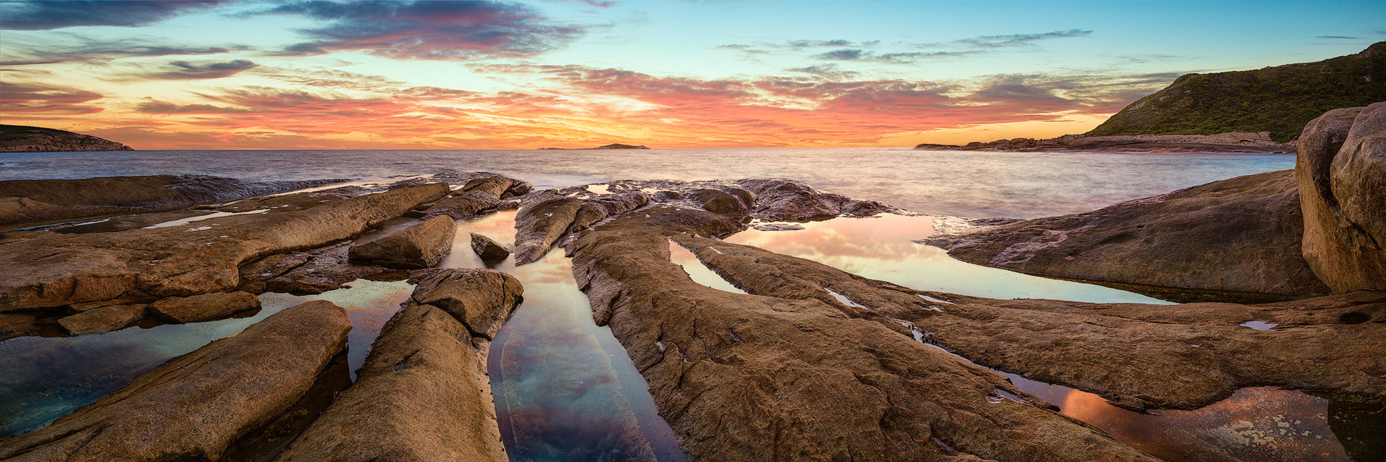 Observation point rocky beach with reflections of the clouds in the water at sunset Esperance panorama