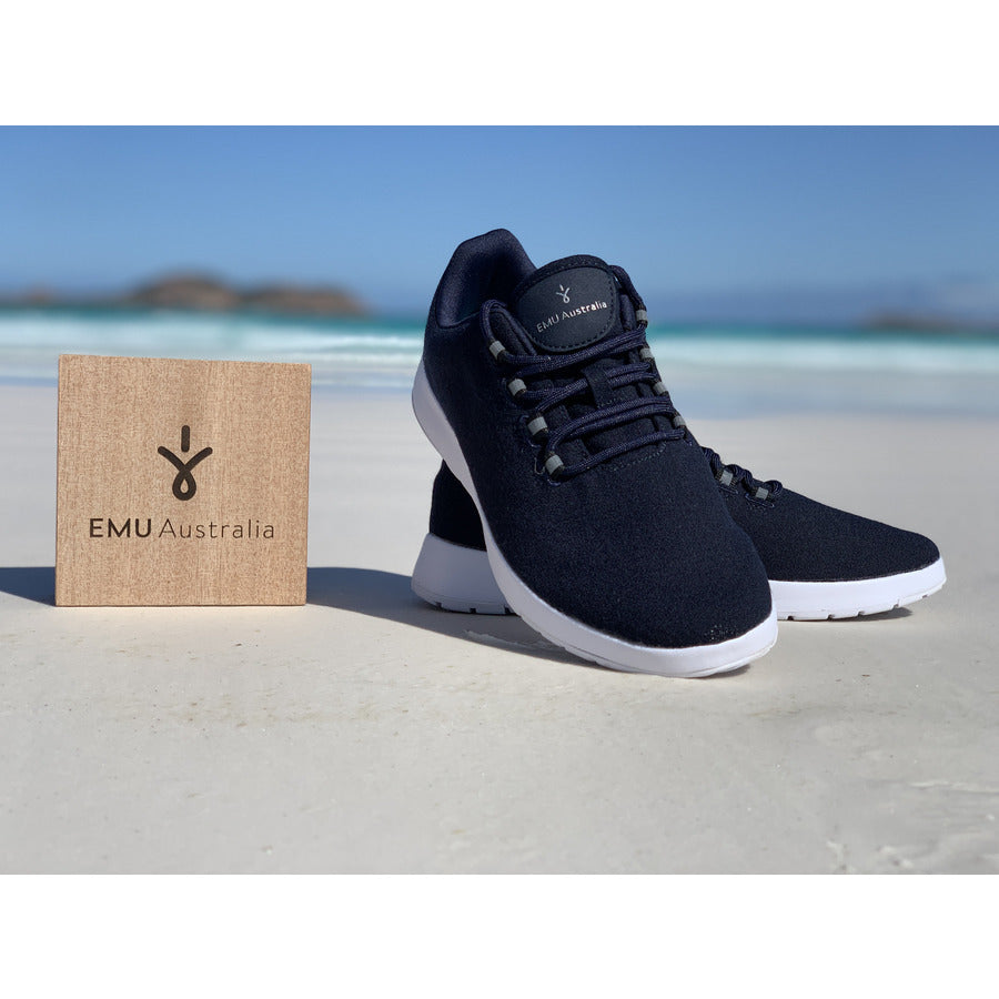Emu Australia Barkly wool sneaker in midnight blue with dark blue laces and a white sole photo on a beach